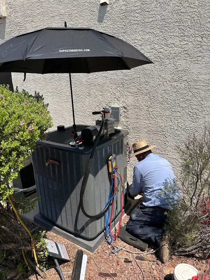 HVAC technician performing outdoor AC maintenance in Angleton